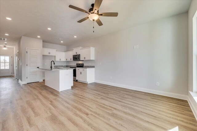 full bathroom with a textured ceiling, shower / bath combination, wood finished floors, vanity, and visible vents