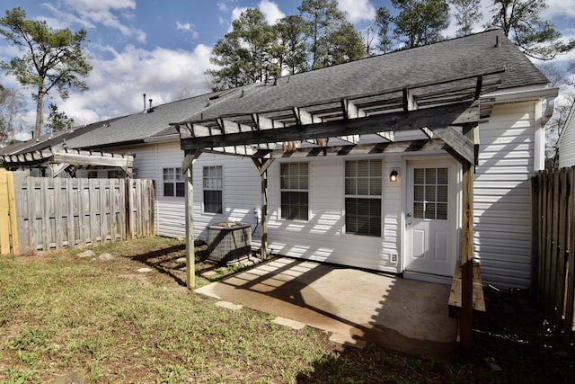 rear view of house featuring a patio area, fence, and a pergola