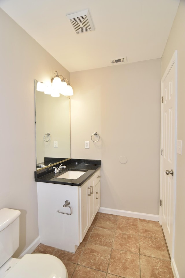 bathroom featuring baseboards, visible vents, vanity, and toilet