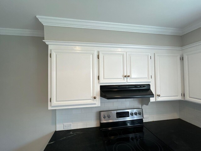 2210 Glendale Rd, Augusta, GA 30904 - kitchen with under cabinet range hood, stainless steel electric range oven, crown molding, white cabinetry, and dark countertops