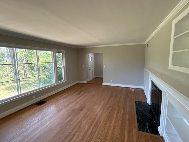 2210 Glendale Rd, Augusta, GA 30904 - unfurnished living room with crown molding, visible vents, a high end fireplace, baseboards, and dark wood-style flooring