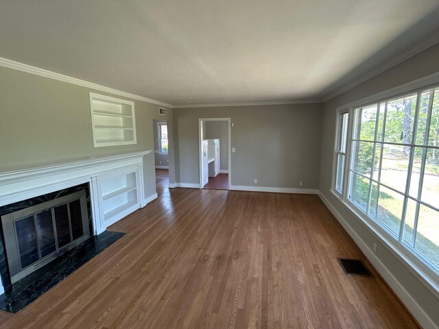 2210 Glendale Rd, Augusta, GA 30904 - unfurnished living room with visible vents, baseboards, a fireplace, dark wood-type flooring, and built in features