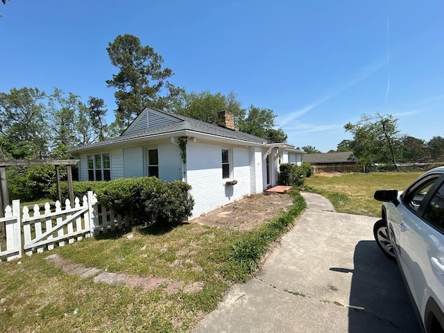 2210 Glendale Rd, Augusta, GA 30904 - view of side of home with a chimney, brick siding, fence, and a yard