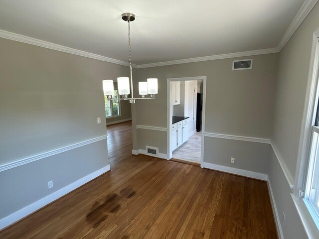 2210 Glendale Rd, Augusta, GA 30904 - unfurnished dining area with visible vents, wood finished floors, a chandelier, and baseboards