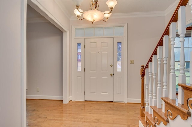 foyer entrance featuring stairway, light wood-style floors, and ornamental molding