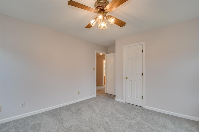 unfurnished bedroom featuring a ceiling fan, baseboards, and carpet floors