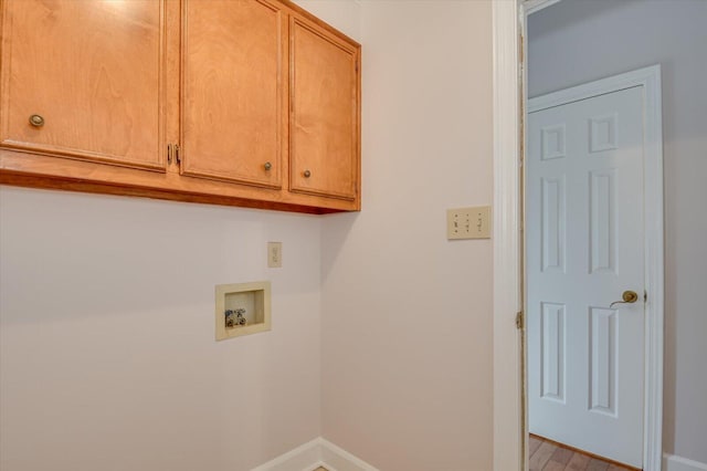 laundry area featuring washer hookup, cabinet space, and baseboards