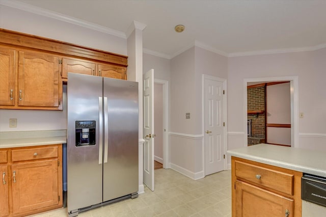 kitchen featuring light countertops, brown cabinetry, stainless steel fridge, and ornamental molding