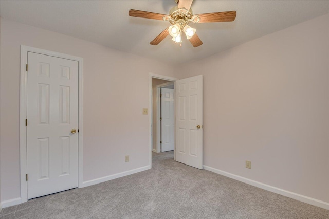 unfurnished bedroom with baseboards, carpet floors, and a ceiling fan