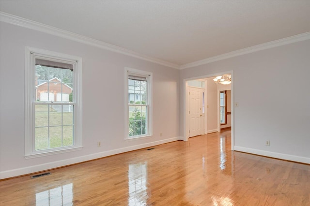 empty room with a wealth of natural light, visible vents, baseboards, and light wood-style floors