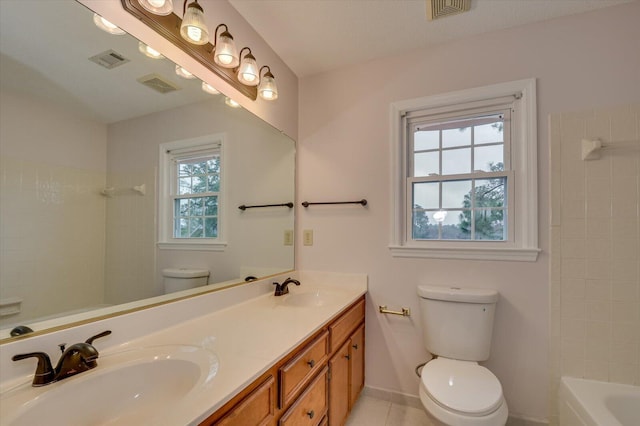 bathroom featuring visible vents, toilet, and a sink