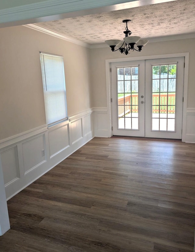 209 Biltmore Ct, Martinez, GA 30907 - unfurnished dining area with a chandelier, wainscoting, a decorative wall, crown molding, and dark wood finished floors