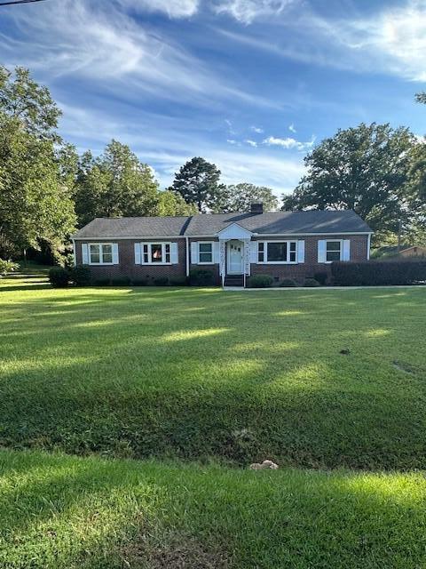 ranch-style home with a front lawn