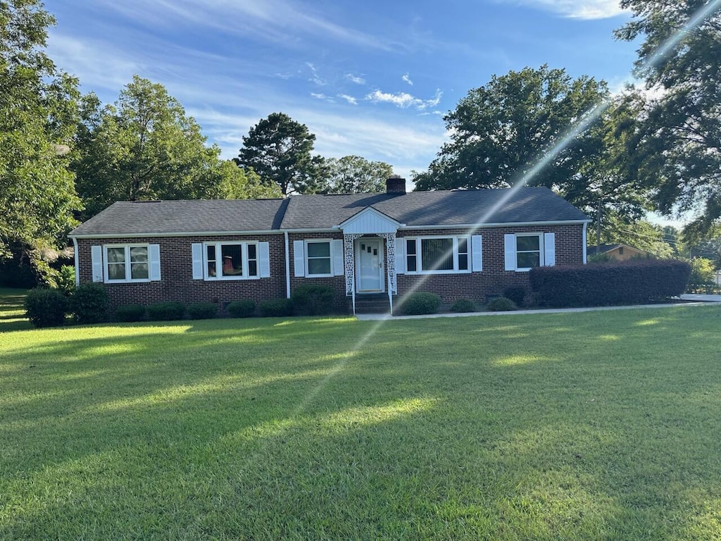 single story home featuring a front lawn