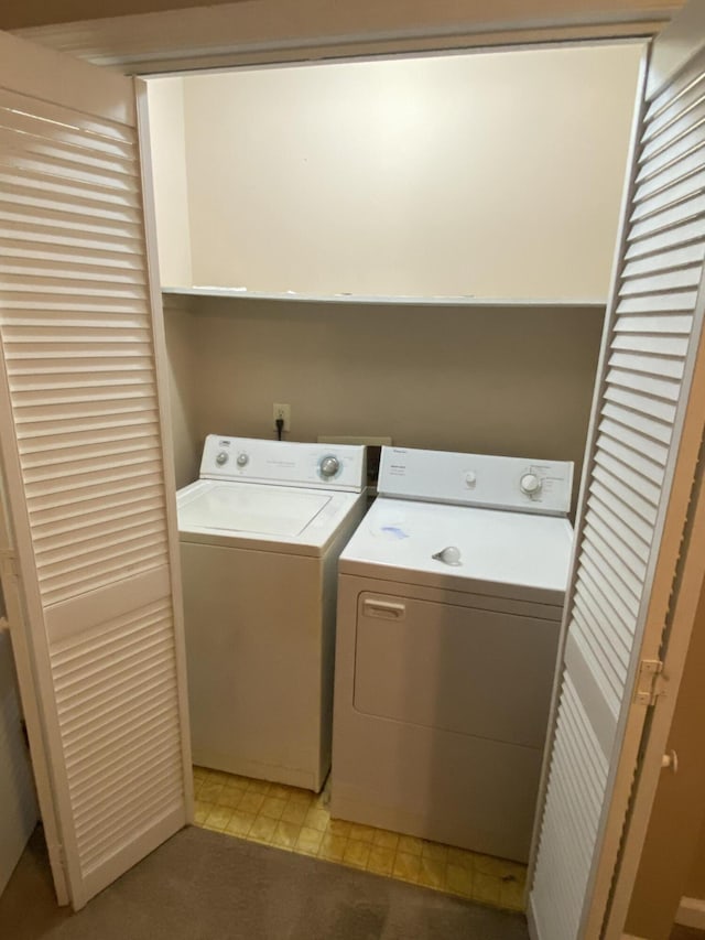 clothes washing area featuring washing machine and clothes dryer