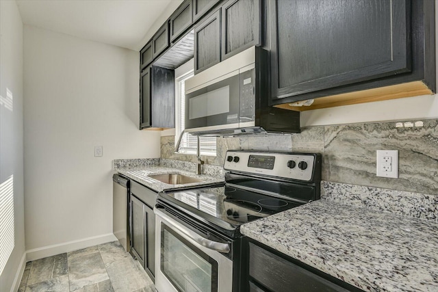 kitchen with sink, light stone countertops, and stainless steel appliances