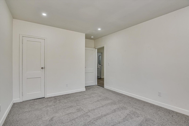 unfurnished room with light colored carpet