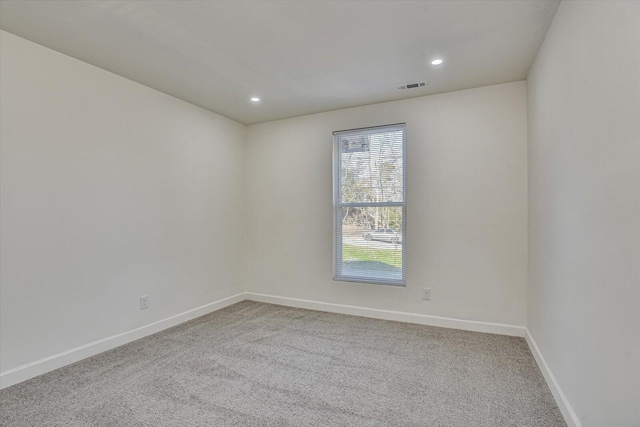 unfurnished room featuring light colored carpet