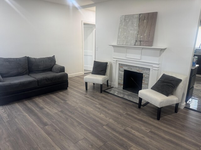 unfurnished living room featuring a stone fireplace and light wood-type flooring