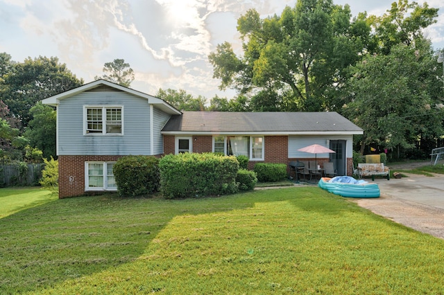 split level home featuring a patio and a front yard