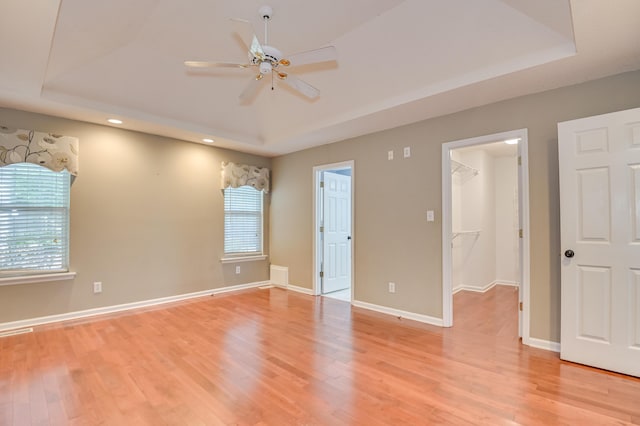 790 Osprey Ln, Martinez, GA 30907 - unfurnished bedroom featuring a raised ceiling, multiple windows, light wood finished floors, and recessed lighting