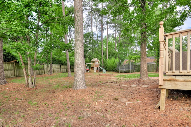 790 Osprey Ln, Martinez, GA 30907 - fenced backyard with a trampoline, a playground, and a wooden deck