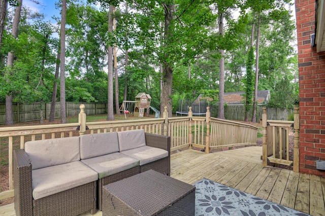 790 Osprey Ln, Martinez, GA 30907 - deck featuring outdoor lounge area, a playground, a fenced backyard, a trampoline, and view of wooded area