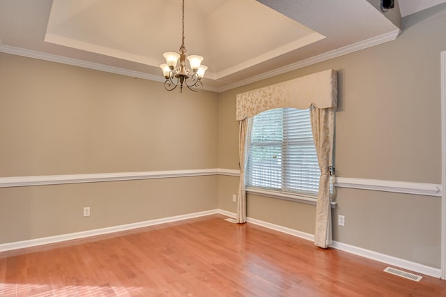 790 Osprey Ln, Martinez, GA 30907 - spare room featuring a raised ceiling, a chandelier, wood finished floors, crown molding, and baseboards