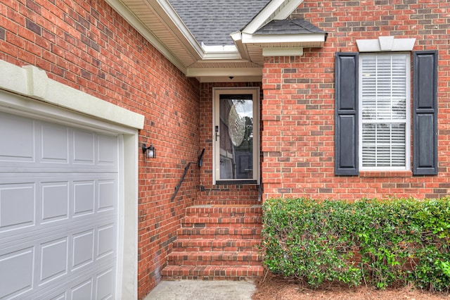 790 Osprey Ln, Martinez, GA 30907 - view of exterior entry featuring brick siding, a garage, and a shingled roof