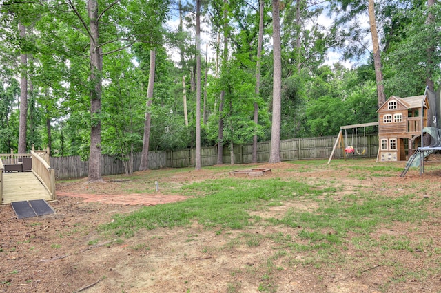 790 Osprey Ln, Martinez, GA 30907 - fenced backyard featuring a playground and view of scattered trees
