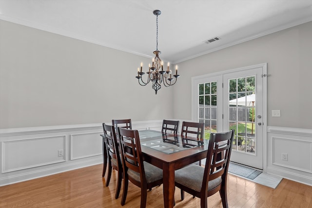 1109 Highmoor Ln, Evans, GA 30809 - dining area with a chandelier, ornamental molding, light wood finished floors, wainscoting, and a decorative wall