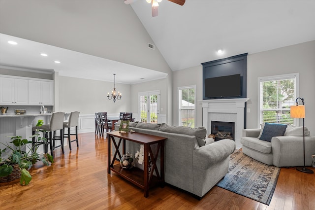 1109 Highmoor Ln, Evans, GA 30809 - living room featuring plenty of natural light, a chandelier, a fireplace, ceiling fan, and high vaulted ceiling