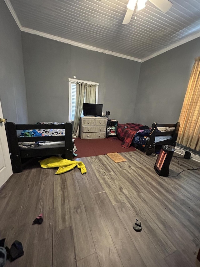 unfurnished bedroom featuring ceiling fan, ornamental molding, and wood finished floors