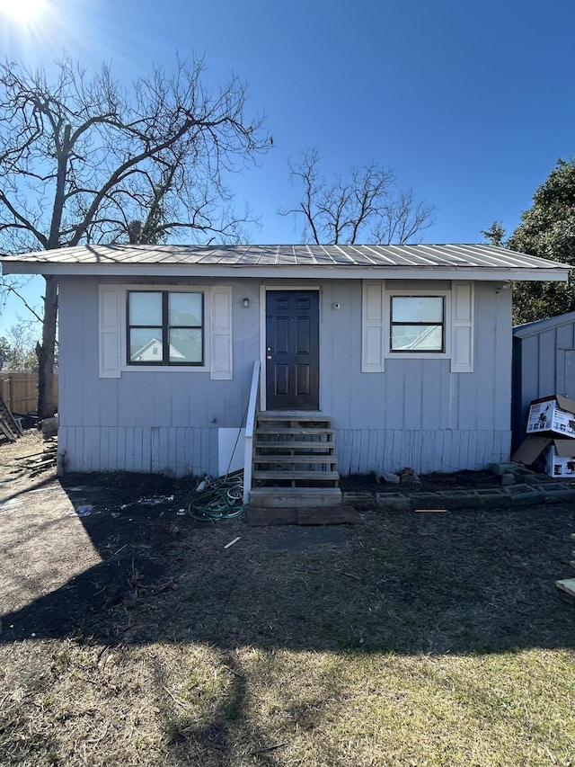 view of front of property with entry steps and metal roof