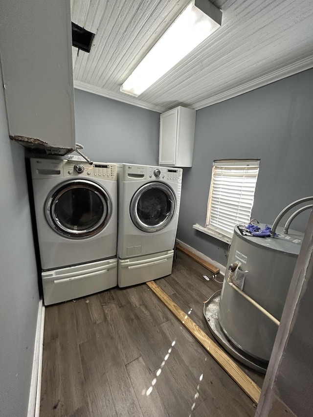 laundry room with dark wood-style floors, crown molding, washing machine and clothes dryer, cabinet space, and baseboards