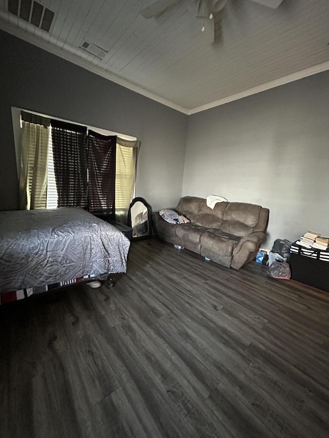 bedroom featuring ornamental molding, visible vents, ceiling fan, and wood finished floors