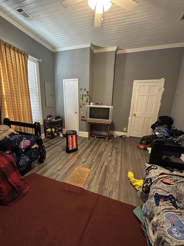 bedroom featuring a ceiling fan, baseboards, ornamental molding, and wood finished floors