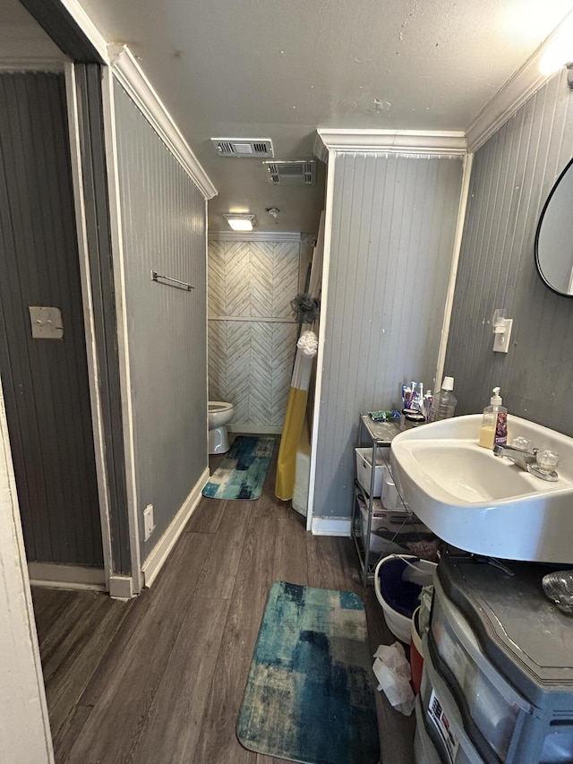 bathroom featuring visible vents, vanity, wood finished floors, and toilet