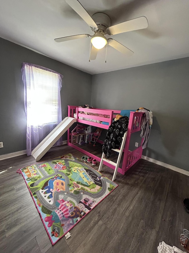 bedroom with ceiling fan, dark wood-style flooring, and baseboards