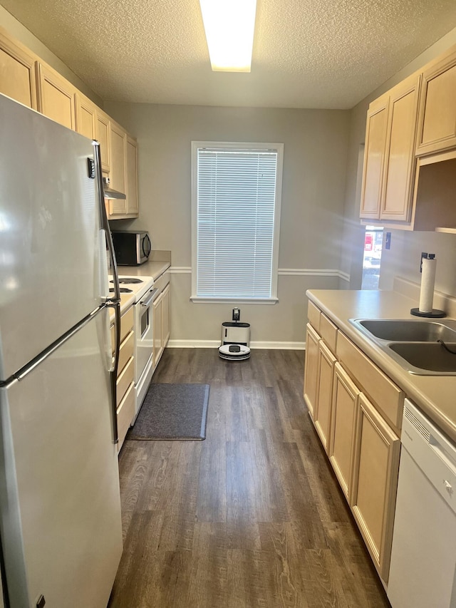 kitchen featuring dark hardwood / wood-style flooring, sink, stainless steel appliances, and a textured ceiling