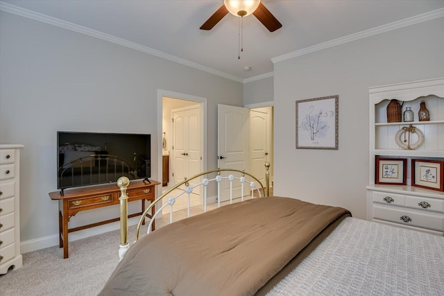 carpeted bedroom featuring baseboards, a ceiling fan, and crown molding