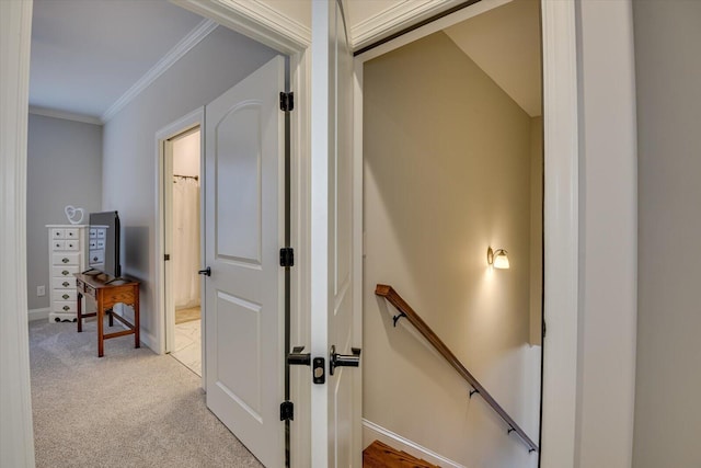 corridor with baseboards, light carpet, crown molding, and an upstairs landing