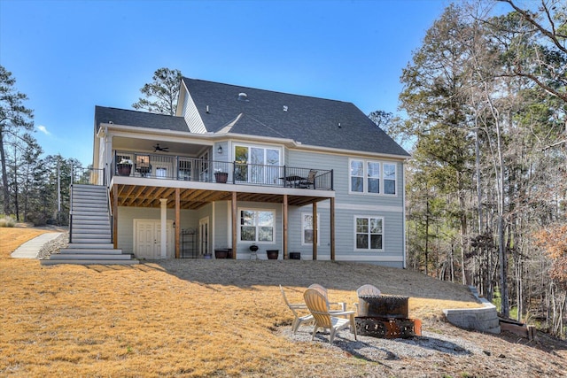 back of house with stairway, a wooden deck, and a ceiling fan