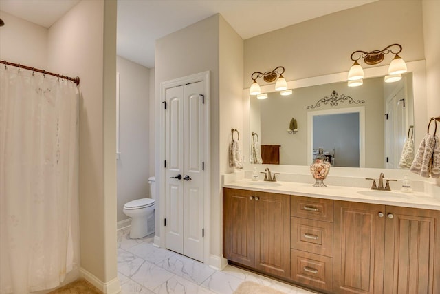 bathroom featuring marble finish floor, a closet, a sink, and toilet