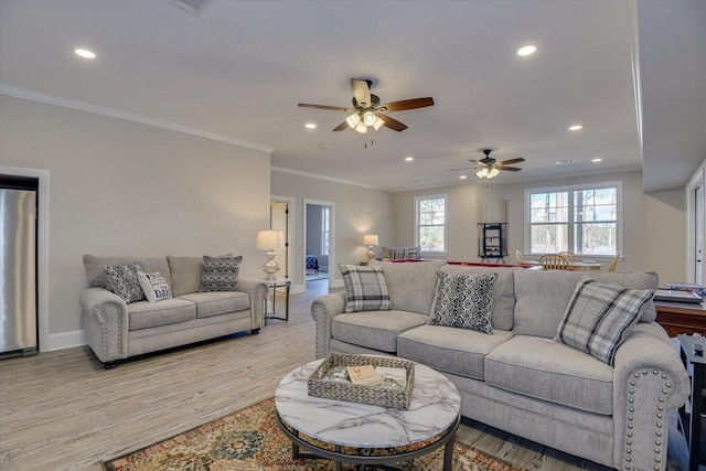 living room featuring light wood-style flooring, ornamental molding, and recessed lighting