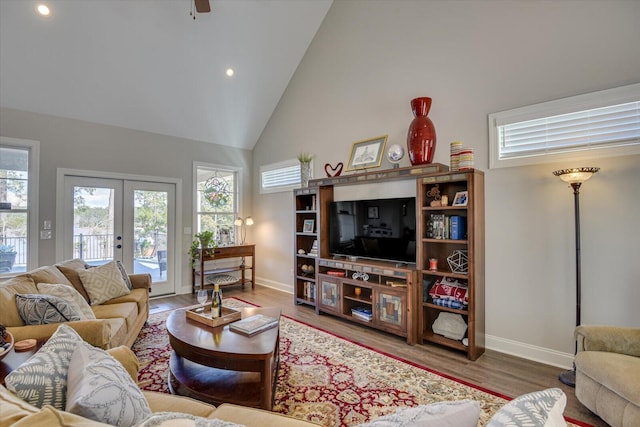 living room with high vaulted ceiling, french doors, wood finished floors, and baseboards