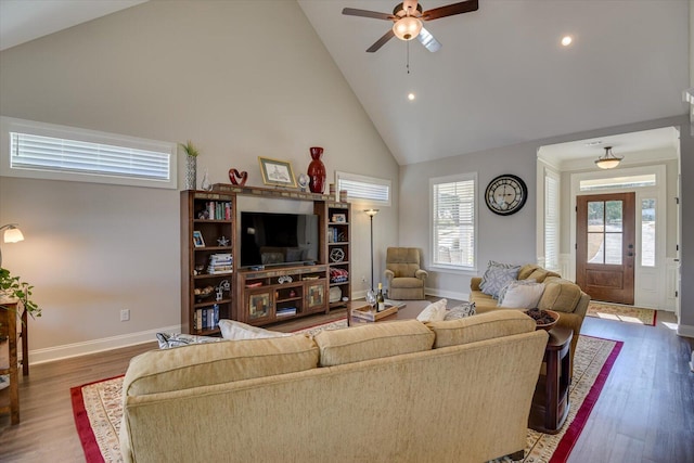 living room featuring high vaulted ceiling, dark wood-style flooring, and baseboards