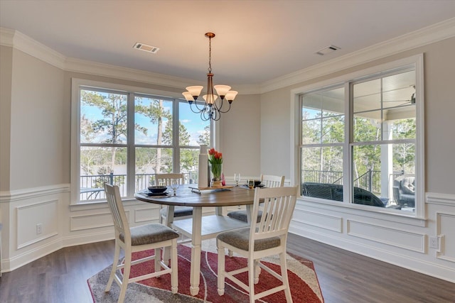 dining space featuring a healthy amount of sunlight, visible vents, and dark wood-type flooring