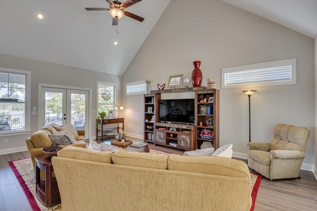 living room featuring french doors, baseboards, and wood finished floors