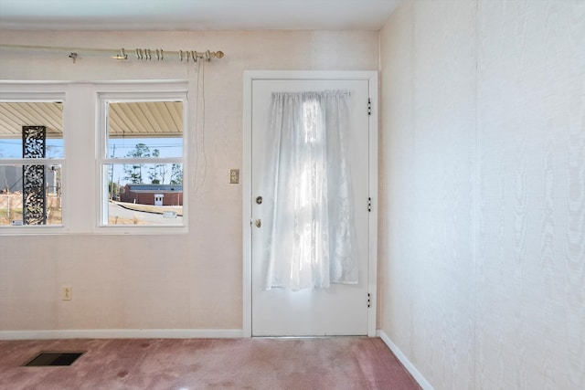 doorway with carpet floors